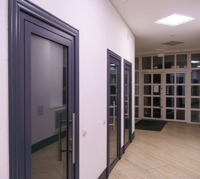 corridor-urbantype-office-building-modern-interior-lobby-office-building-with-glass-doors-clean-white-walls-lighted-long-corridor-modern-business-center